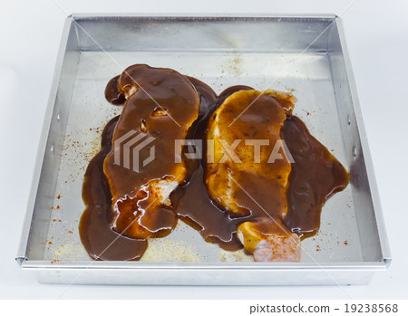 Raw pork fillet with barbecue sauce in baking tin Raw pork fillet with barbecue sauce in baking tin 19238568