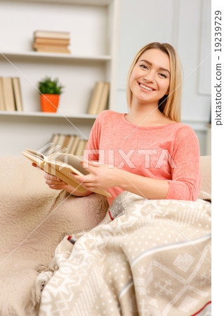 Young pleasant woman reading a book.  19239729