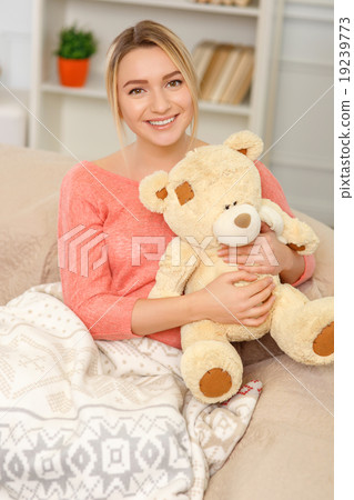 Young smiling woman posing with teddy bear. Young smiling woman posing with teddy bear. 19239773