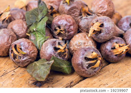 Healthy ripe Medlars on the old wooden table 19239907