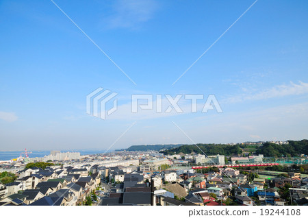 Keikyu train running in the residential area of Yokosuka far behind the Uraga Suido Keikyu train running in the residential area of Yokosuka far behind the Uraga Suido 19244108