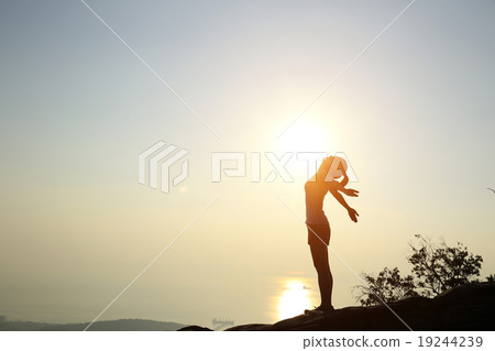 cheering woman open arms at sunset mountain peak 19244239