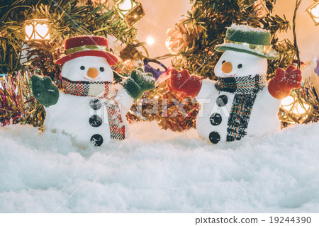 Snowman stand among pile of snow with a light bulb Snowman stand among pile of snow with a light bulb 19244390