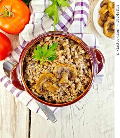 Buckwheat with champignons in clay bowl top 19248815