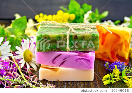 Soap homemade with flowers and leaves on board 19249018