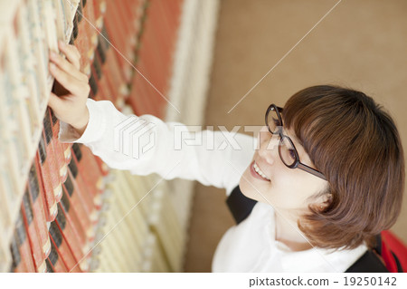 A woman looking for a book 19250142