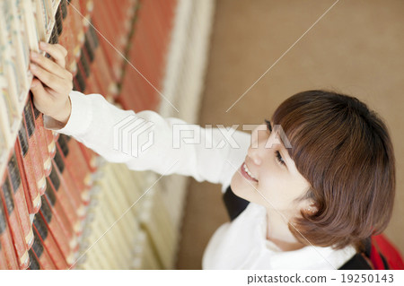 A woman looking for a book 19250143