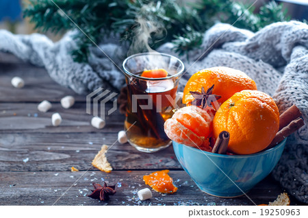 Tangerine in scarf over wooden background Tangerine in scarf over wooden background 19250963