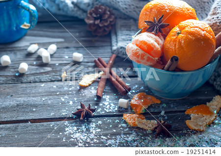 Tangerine in scarf over wooden background Tangerine in scarf over wooden background 19251414