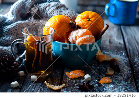 Tangerine in scarf over wooden background Tangerine in scarf over wooden background 19251416