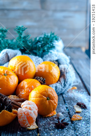 Tangerine in scarf over wooden background 19251418