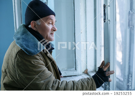 Homeless man is looking out of the window. Homeless man is looking out of the window. 19253255