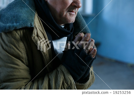 Old homeless man is praying for help. Old homeless man is praying for help. 19253256