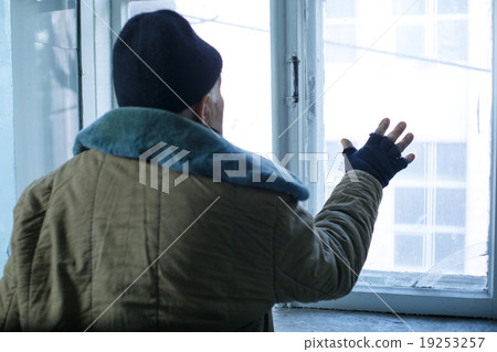 Homeless man is looking out of the window. Homeless man is looking out of the window. 19253257