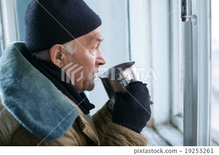 Homeless man holding his iron cup. Homeless man holding his iron cup. 19253261