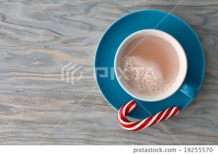 Cocoa cup with a striped candy cane Cocoa cup with a striped candy cane 19255570