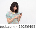 A woman with a smartphone A woman with a smartphone 19256493