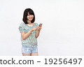 A woman with a smartphone A woman with a smartphone 19256497