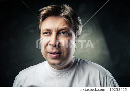 emotional thoughtful middle aged man over gray 19258425