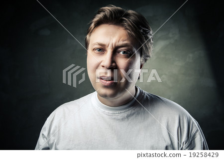 emotional middle aged doubting man over gray emotional middle aged doubting man over gray 19258429