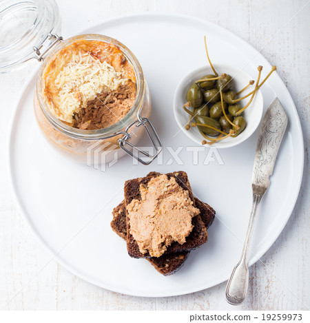 Baked meat pate in jar and on bread Gourmet food 19259973