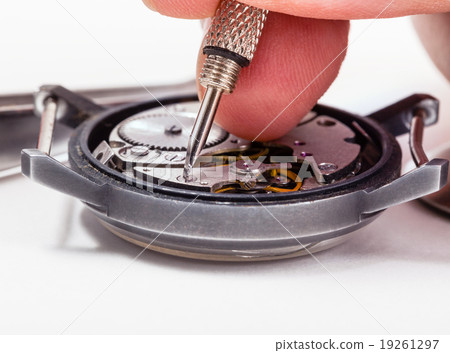 watch repairer repairs old watch close up 19261297