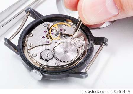 horologist repairs old watch close up 19261469