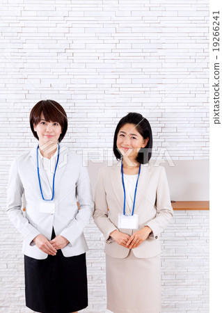 Two women in front of the business reception counter Two women in front of the business reception counter 19266241