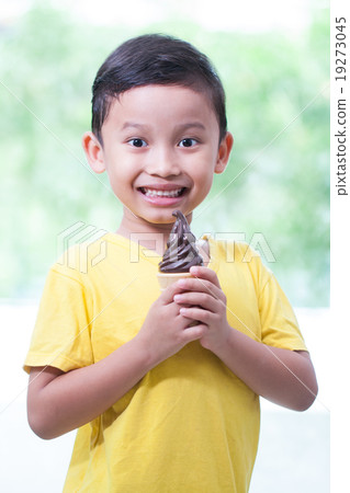 Happy asian boy eating chocolate ice-cream. 19273045