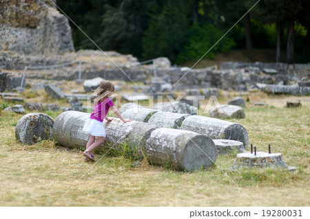 A girl sightseeing historical ruins of Asclepieion A girl sightseeing historical ruins of Asclepieion 19280031