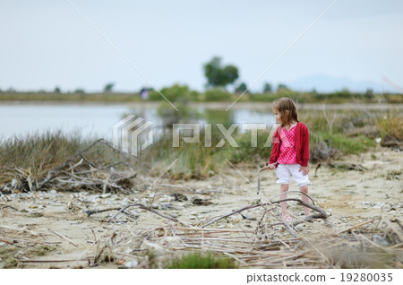 Little girl on Tigaki lake beach Little girl on Tigaki lake beach 19280035