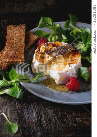 Baked Goat cheese with honey and raspberries Baked Goat cheese with honey and raspberries 19281383