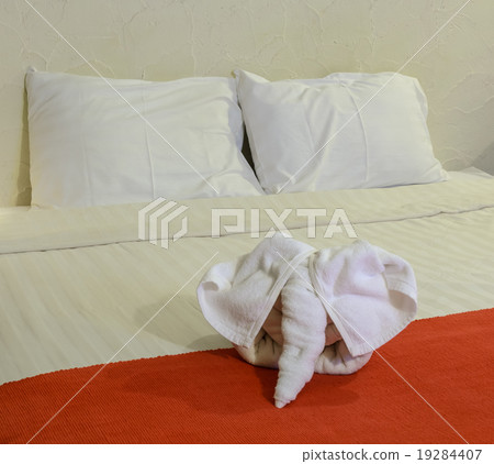 White towel in form of elephant on bed White towel in form of elephant on bed 19284407
