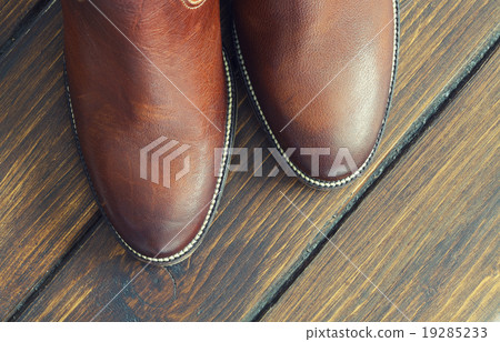 Brown Shoes on a Wooden Background Brown Shoes on a Wooden Background 19285233