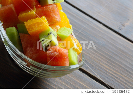 Fresh fruits salad on wooden table 19286482