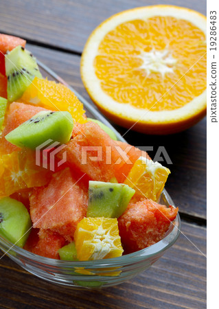 Fresh fruits salad on wooden table 19286483