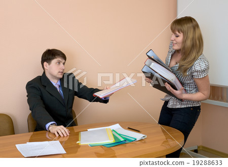 Secretary gives a folders to the chief 19288633
