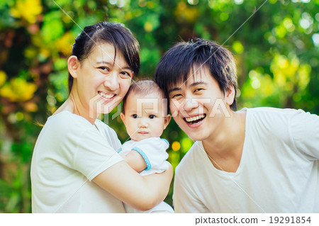 happy family smiling together in the garden happy family smiling together in the garden 19291854
