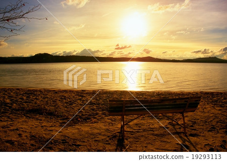 Melancholy evening, bench on autumn beach. Melancholy evening, bench on autumn beach. 19293113