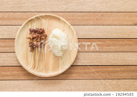 Grilled pork with bamboo stick and Thai sticky rice on wooden di Grilled pork with bamboo stick and Thai sticky rice on wooden di 19294585