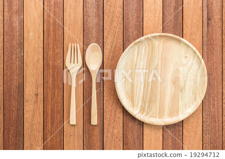 Empty wooden dish, fork and spoon on wooden table Empty wooden dish, fork and spoon on wooden table 19294712