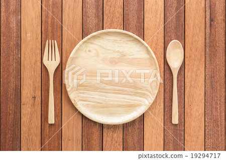 Empty wooden dish, fork and spoon on wooden table Empty wooden dish, fork and spoon on wooden table 19294717