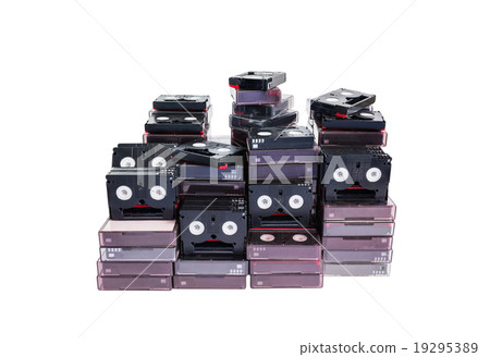Isolated abandoned pile of old useless mini DV Isolated abandoned pile of old useless mini DV 19295389