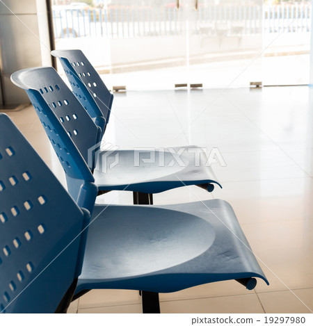 customer waiting area with rows of blue seats 19297980