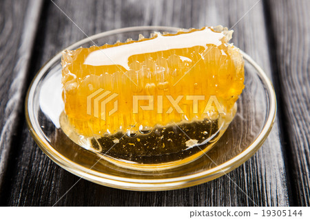 Honeycomb on a glass saucer Honeycomb on a glass saucer 19305144