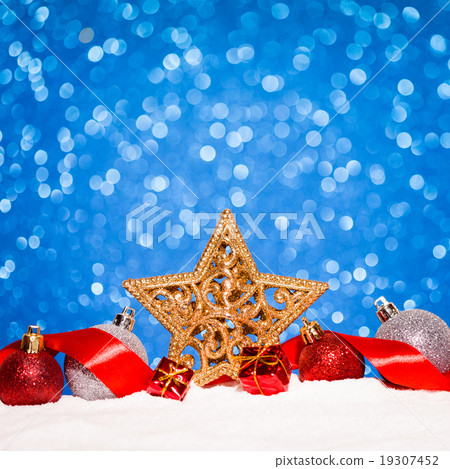 christmas ornament in snow on glitter background christmas ornament in snow on glitter background 19307452