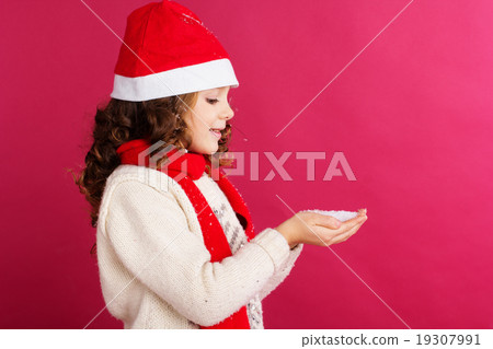 Child girl is holding fake snow in hands Child girl is holding fake snow in hands 19307991