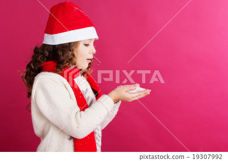 Child girl is holding fake snow in hands Child girl is holding fake snow in hands 19307992