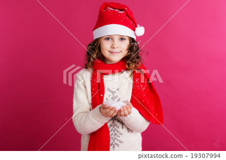 Little girl is holding fake snow in hands Little girl is holding fake snow in hands 19307994