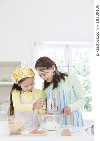 Mother and daughter standing in the kitchen Mother and daughter standing in the kitchen 19309136